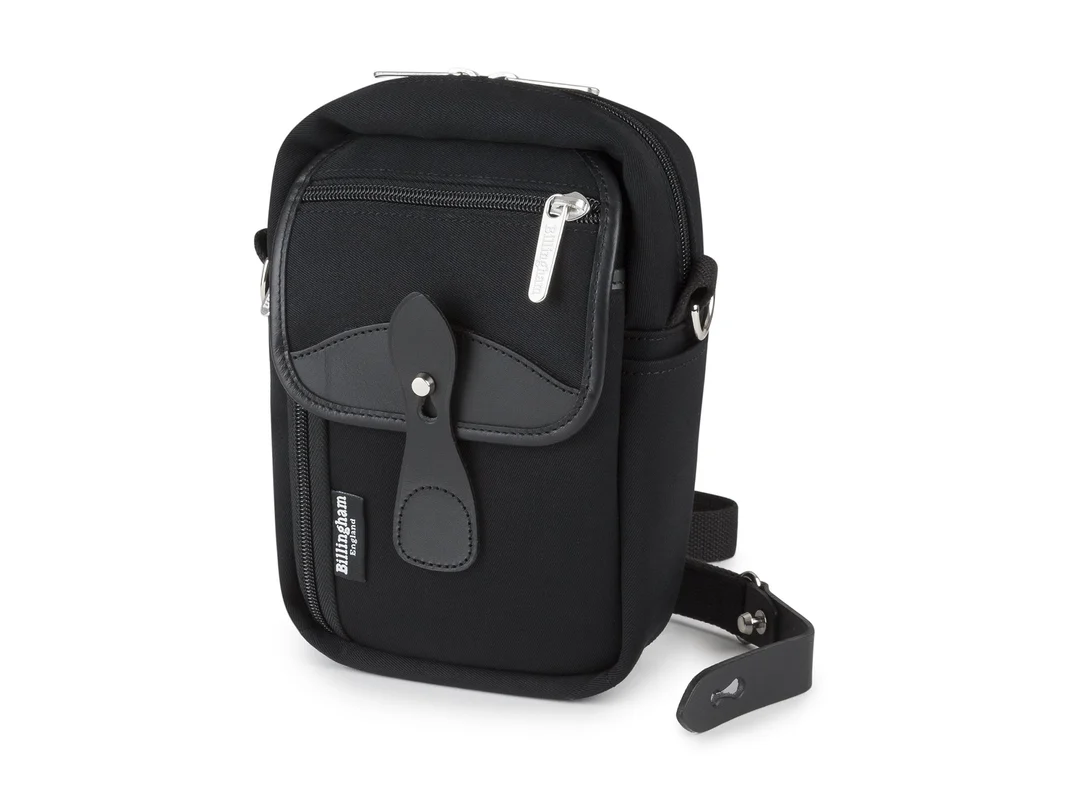 Black Billingham camera bag with a front pocket, zip closure, and a detachable shoulder strap.