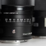 Product image shows 50mm L-Mount lenses from Leica, Panasonic, Sigma