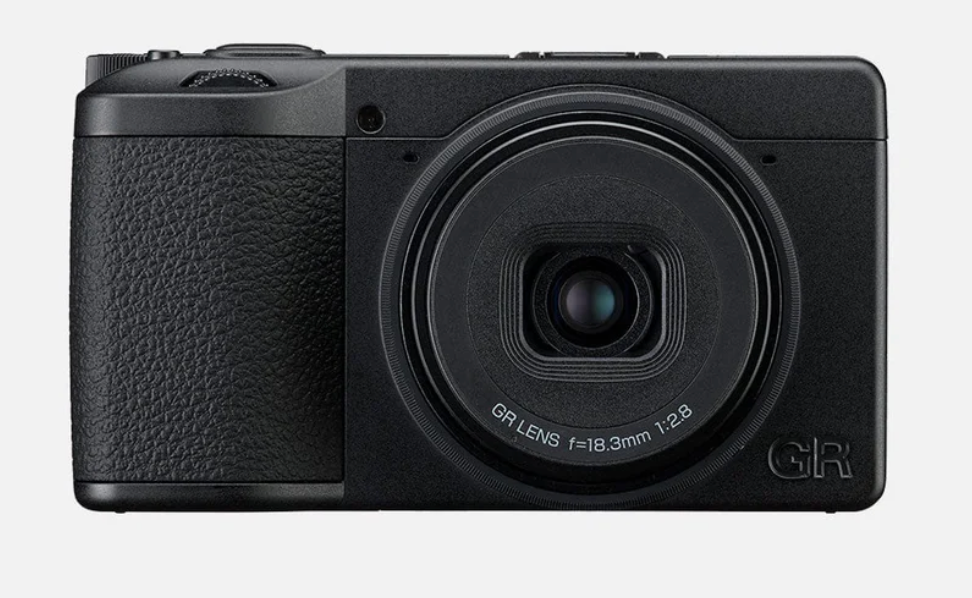 Front view of the Ricoh GR IV Monochrome camera, showcasing its sleek black design and lens.