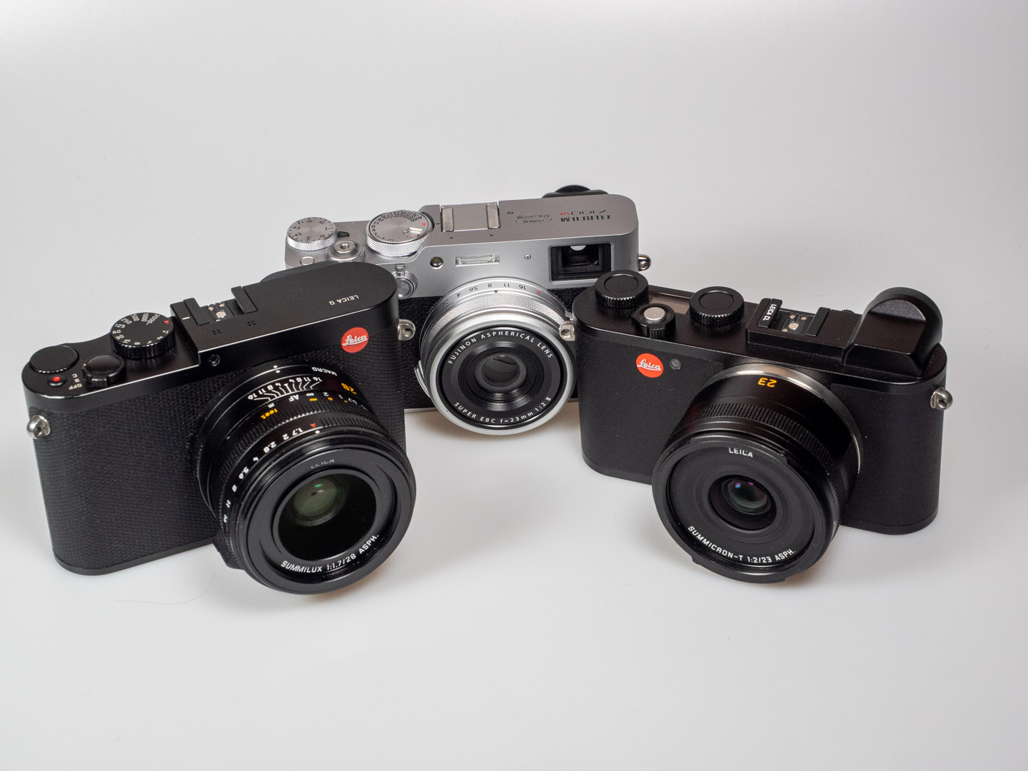 Leica vs. Fujifilm: Product image shows Leica Q. Leica CL, and Fujifilm X-E5.