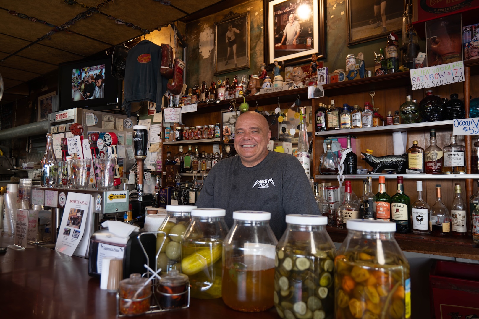 Bald man at a bar.