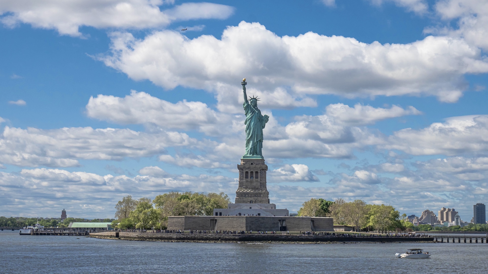 Statue of Liberty monument against a cloudy sky.
