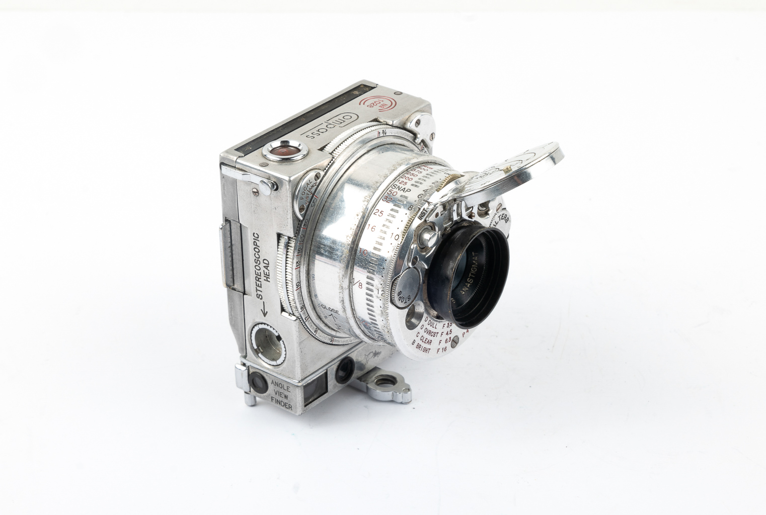 Close-up of a vintage silver camera with a shiny metallic body and a detailed lens, positioned at an angle.