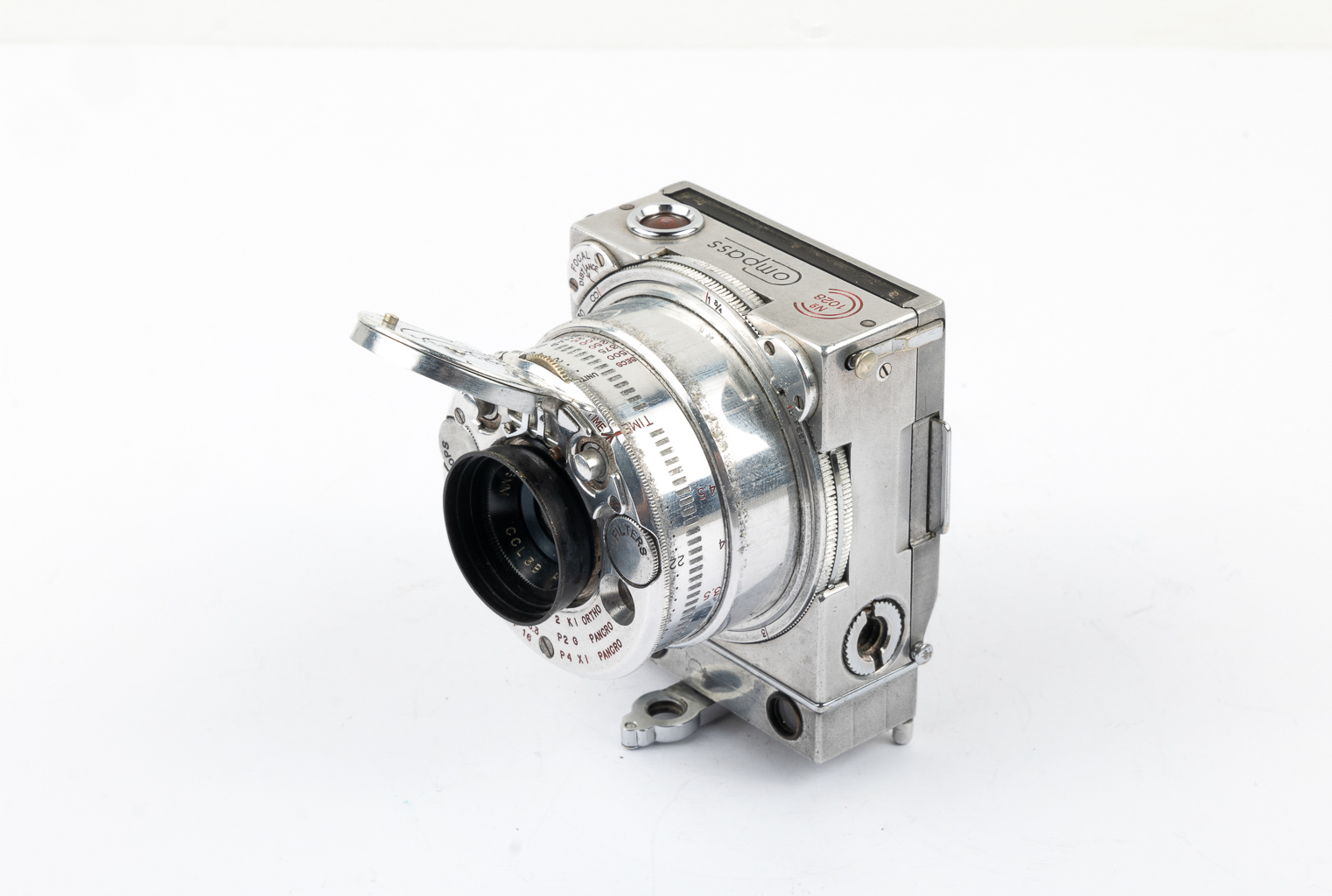 A vintage silver metal camera with a prominent lens and various dials and markings.