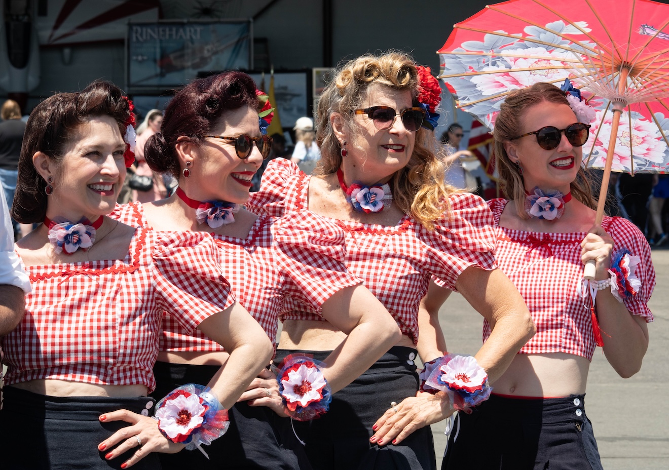 Woman in red-checkered blouses posing in the bright sunlight.