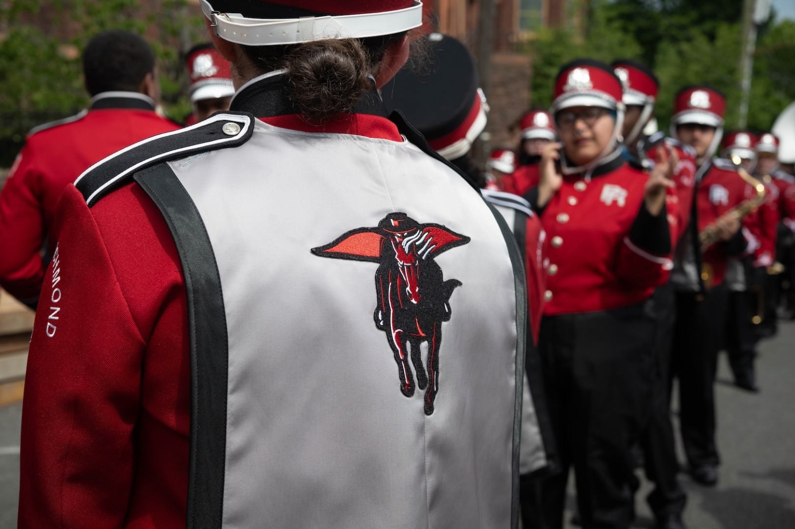 Close-up of red winged-horse on the tunic of a marching band musician.