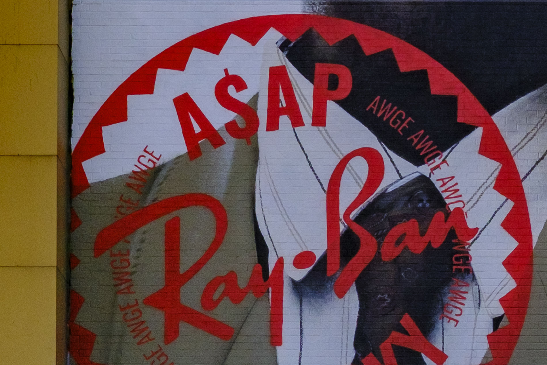 A mural featuring the text 'ASAP' and a stylised 'Ray-Ban' logo, with abstract design elements in red and black.