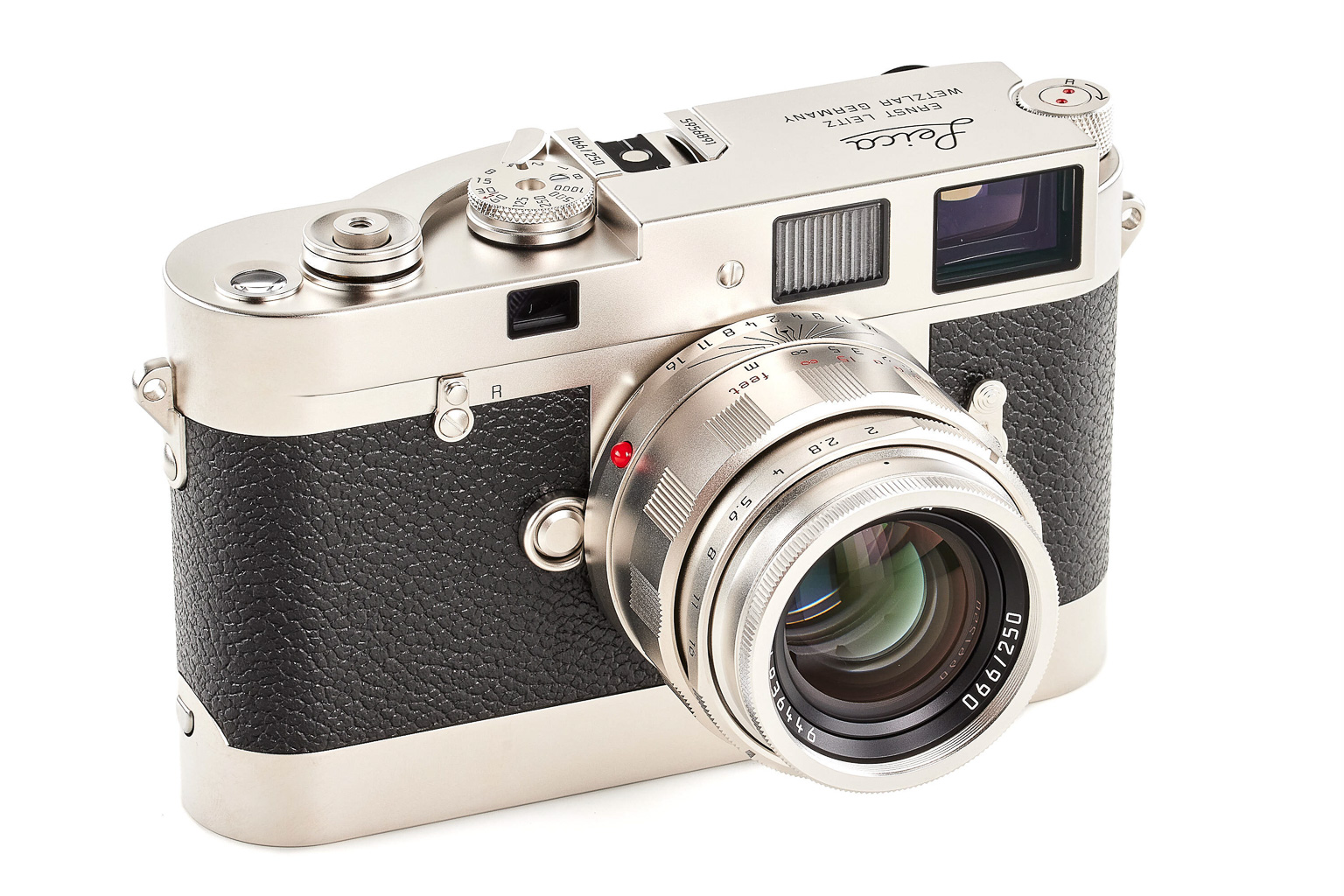 A vintage-style camera with a metallic body and a textured black grip, featuring a lens and various adjustment dials.