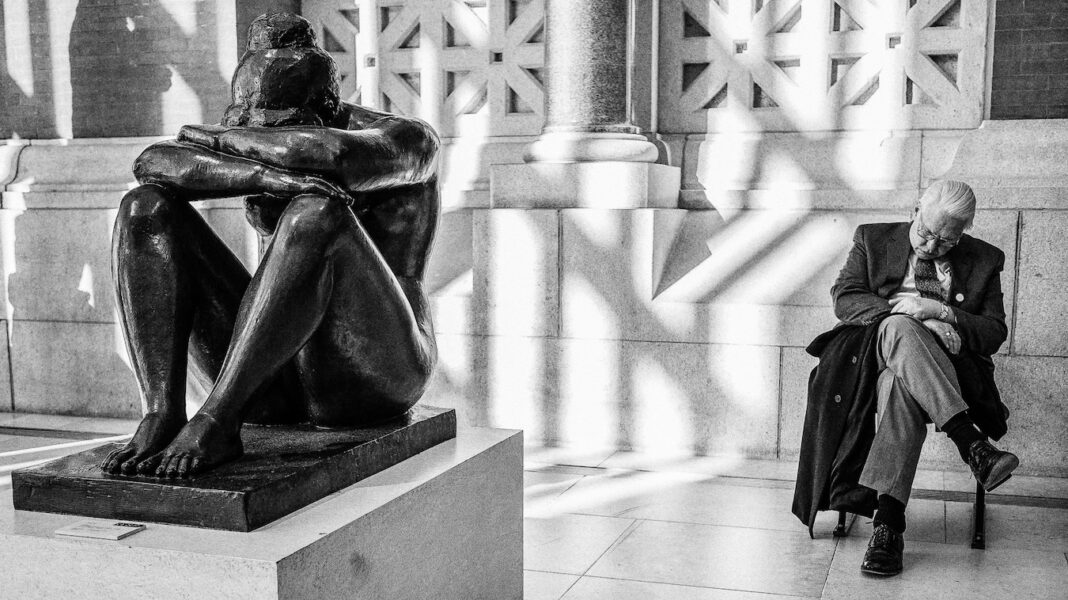 A sleeping female sculpture and a sleeping man.
