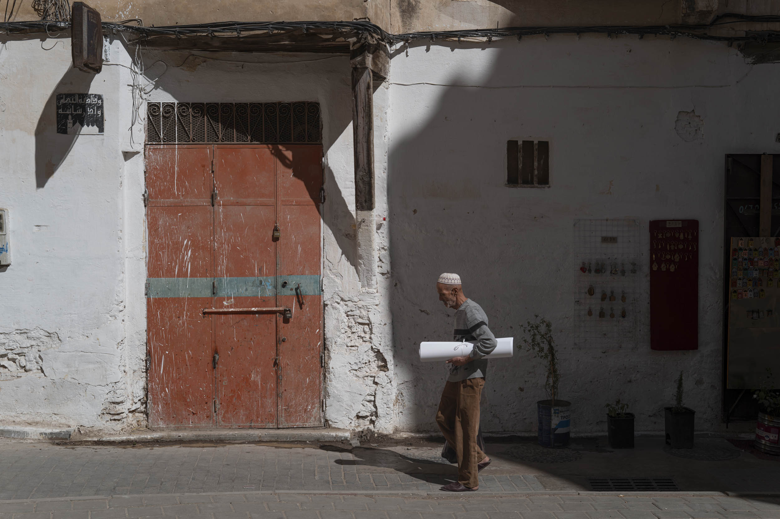 Man walking past old door in Medina
