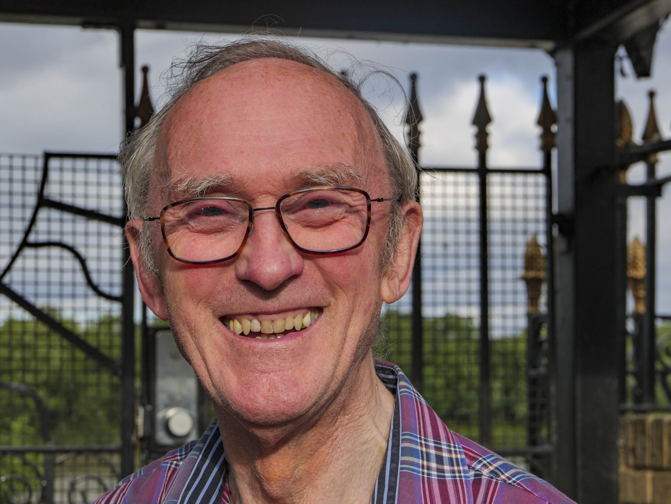 Portrait of man in front of metal gate