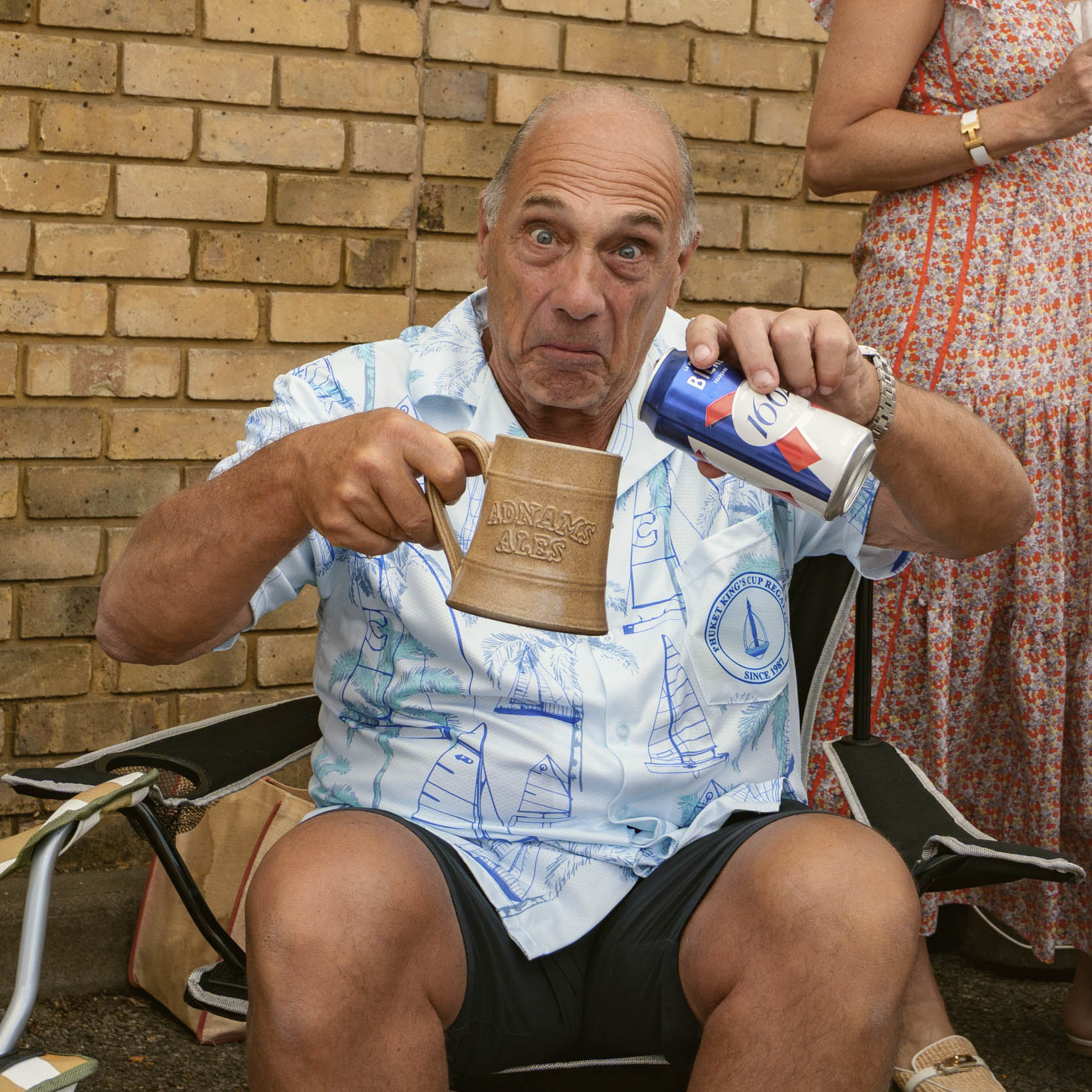 Man with can of beer and Adnams Ales mug
