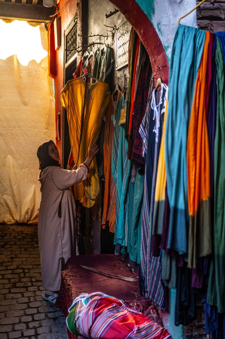 woman in medina looking at fabrics