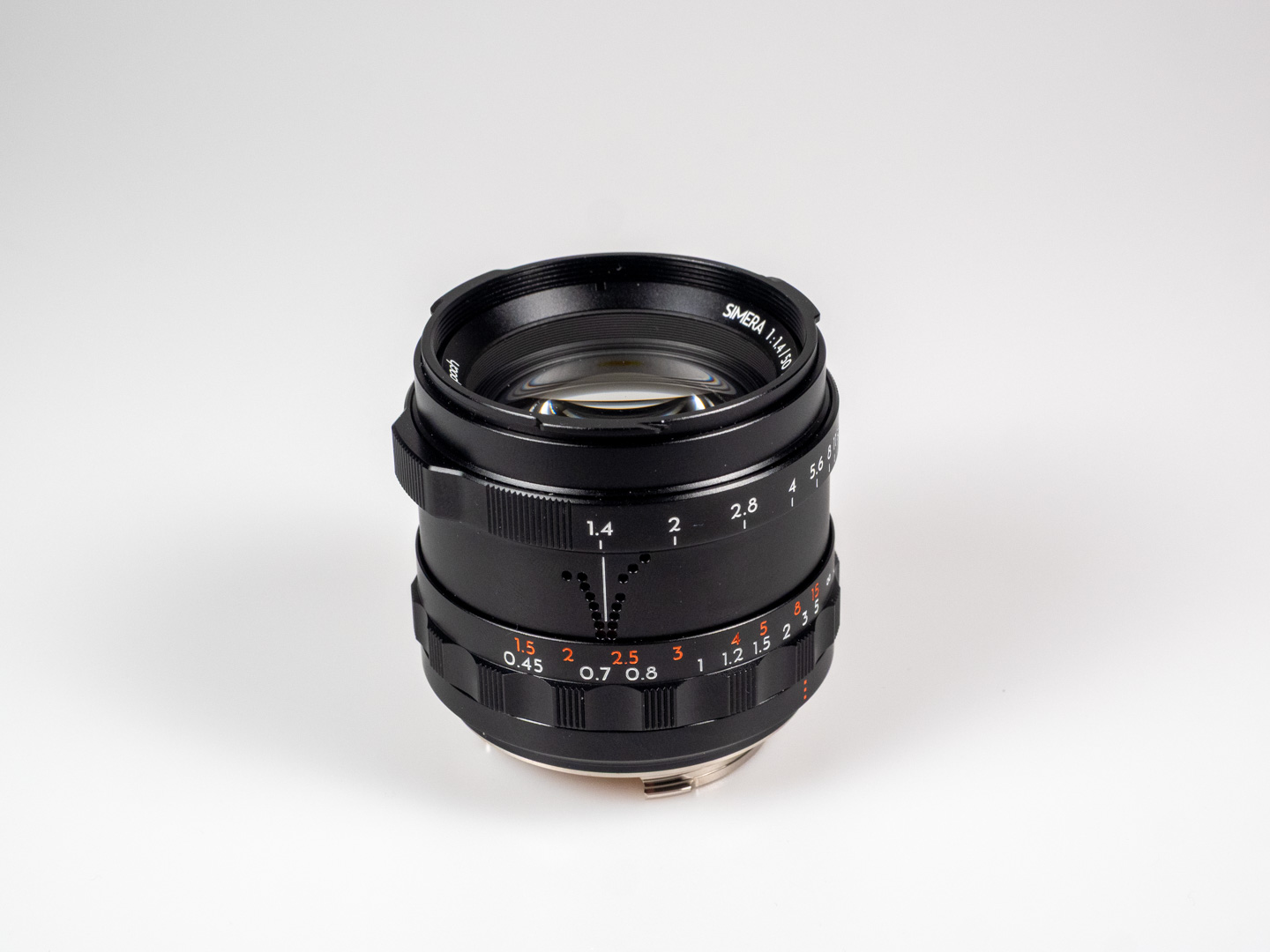 Product shot of Thypoch Simera 50/1.4: angled close-up of the front element and engraved lens markings.