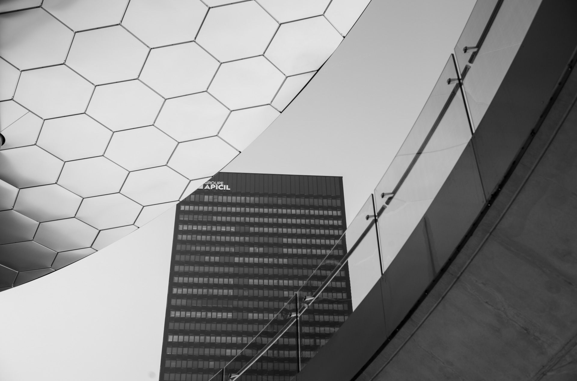 Sample shot with Thypoch Simera 50/1.4: the hexagonal glass canopy of the Part-Dieu shopping centre with the Groupe APICIL tower behind, Lyon, France.