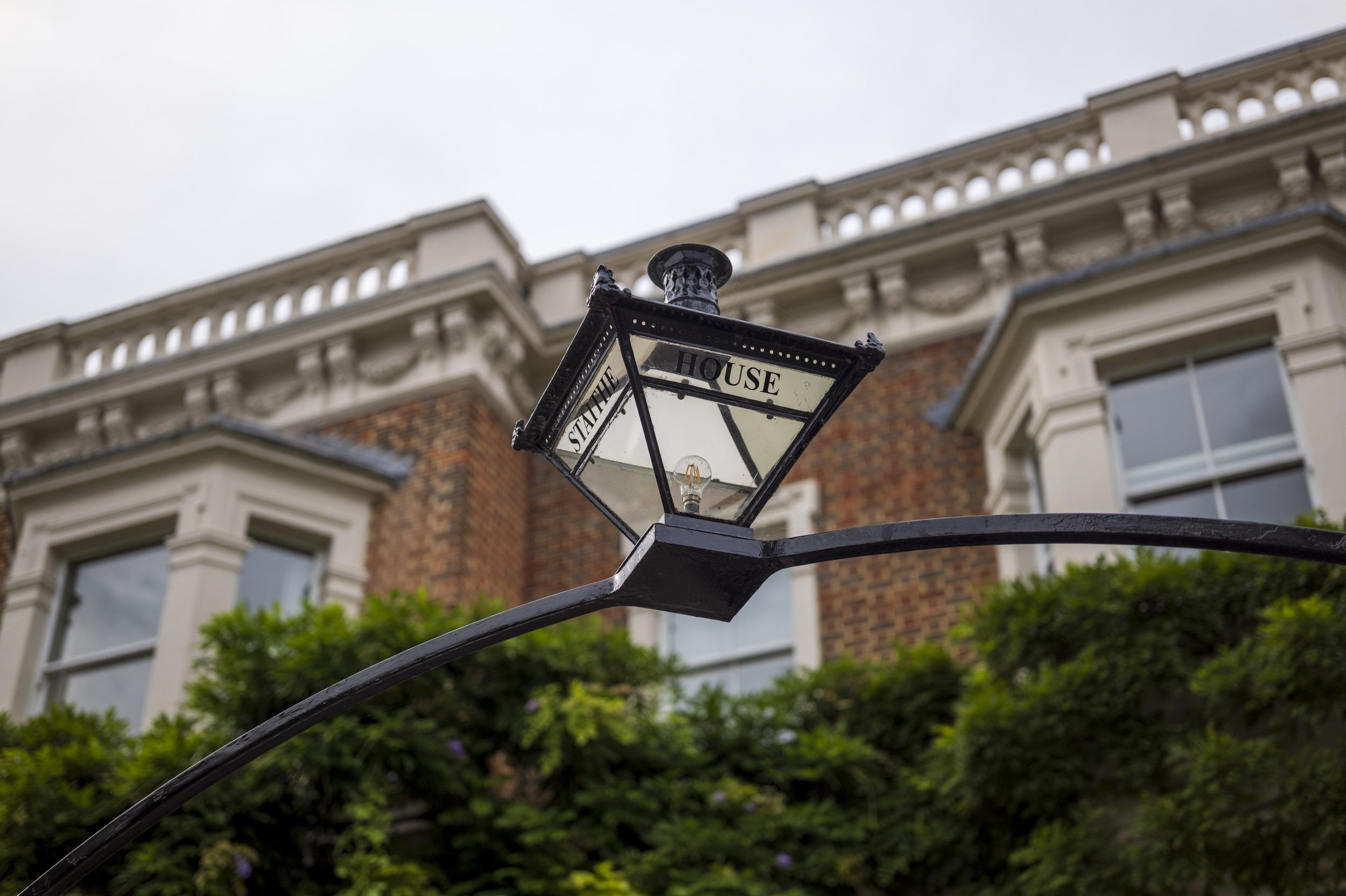 A period street lamp mounted on the wall of 'Staithe House', part of an aperture test series.