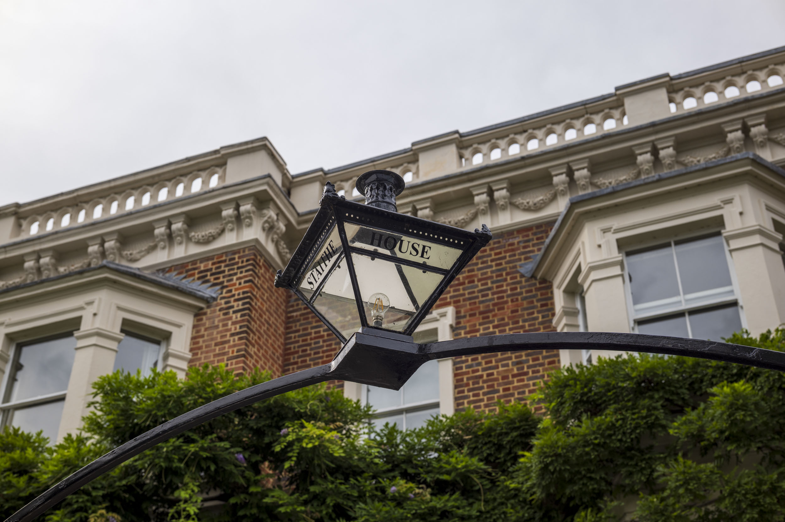 A period street lamp mounted on the wall of 'Staithe House', part of an aperture test series.