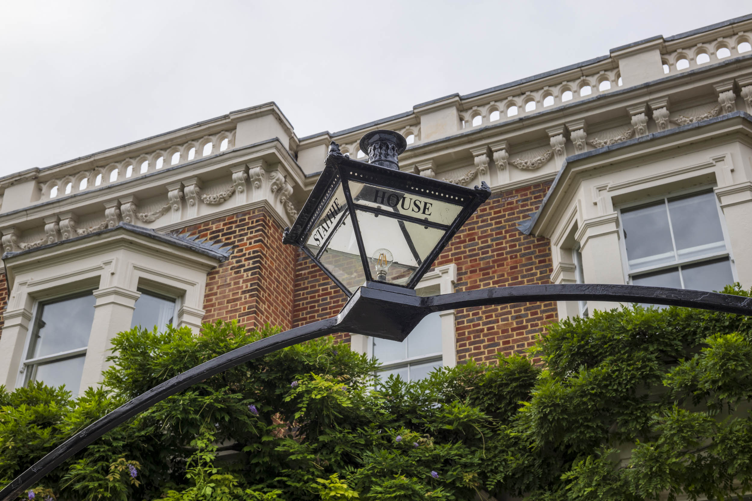 A period street lamp mounted on the wall of 'Staithe House', part of an aperture test series.