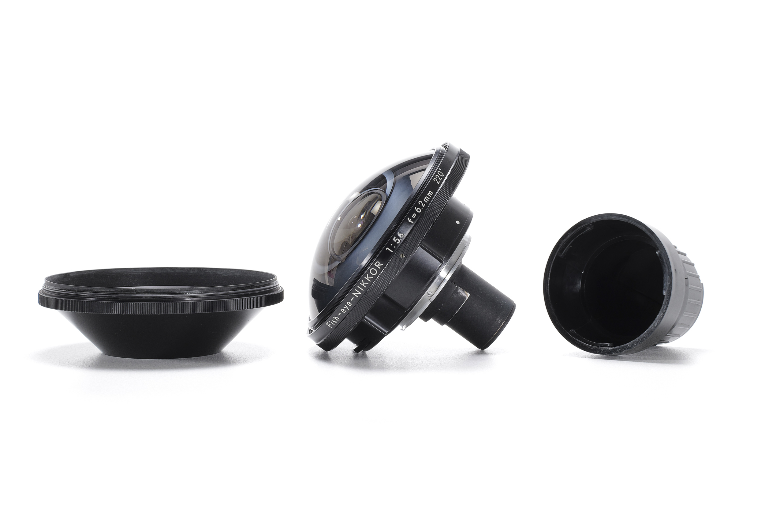 A large black fisheye lens with a domed front element, shown between its front cap and rear cap.