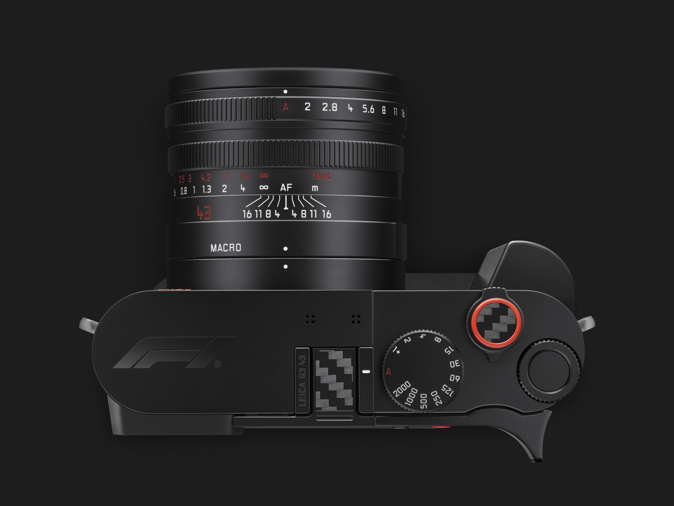 Top view of the camera showing the F1 logo on the top plate, carbon fibre hot-shoe cover, red-rimmed soft release and the lens with its red 43 marking.