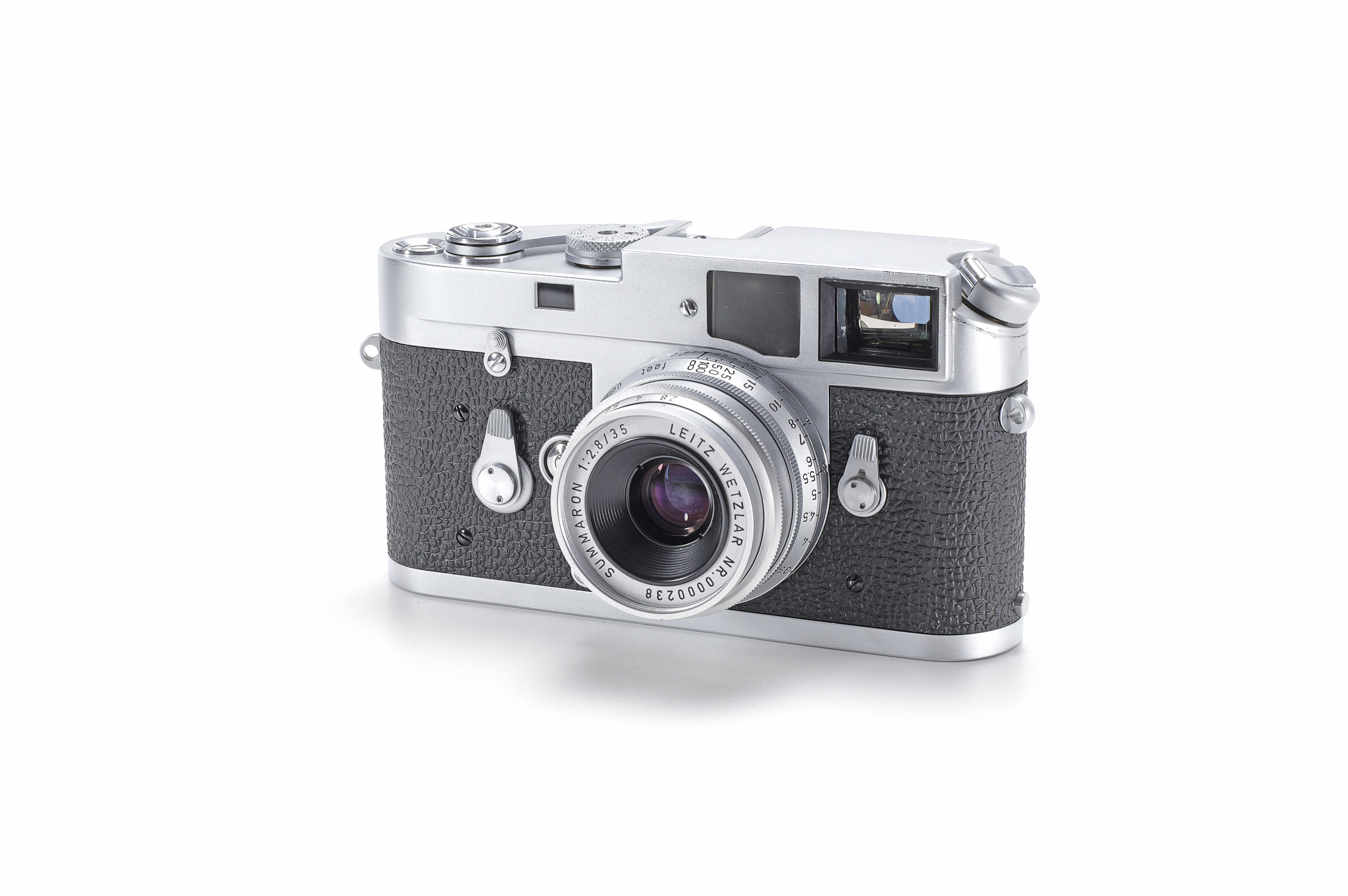A chrome Leica M rangefinder camera with black leatherette and a Summaron 35mm lens, shown at a three-quarter angle.