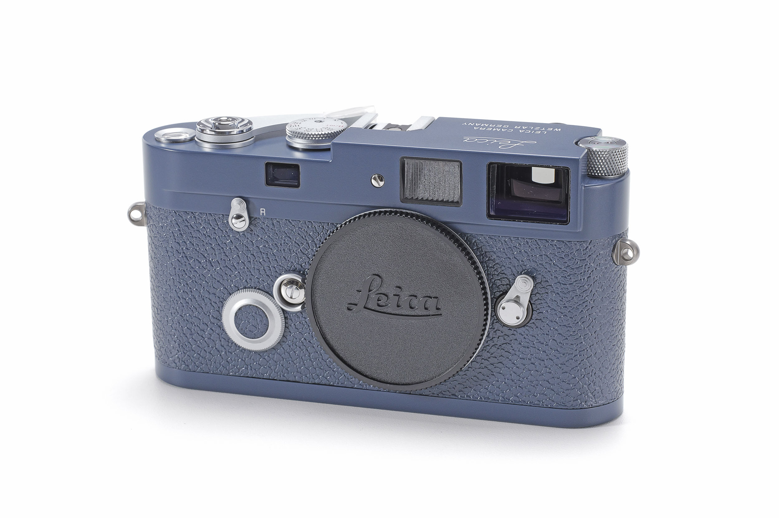 A grey-blue Leica MP camera body with matching textured covering and a black Leica body cap.